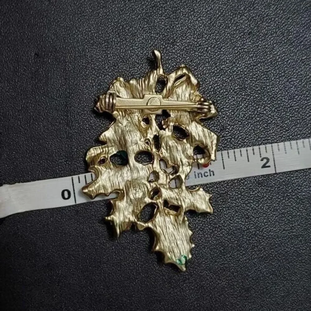 Vintage gold tone holiday holly brooch
